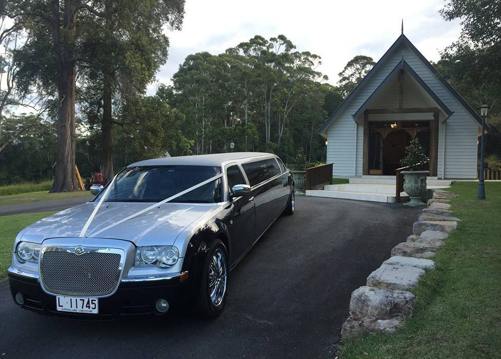Luxury Black Limousine Awaiting in Front of a Church — Superstretch300 Limousines in Sunshine Coast, QLD