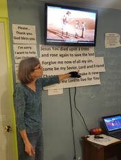 a group of people conducting a bible study outside under a tree