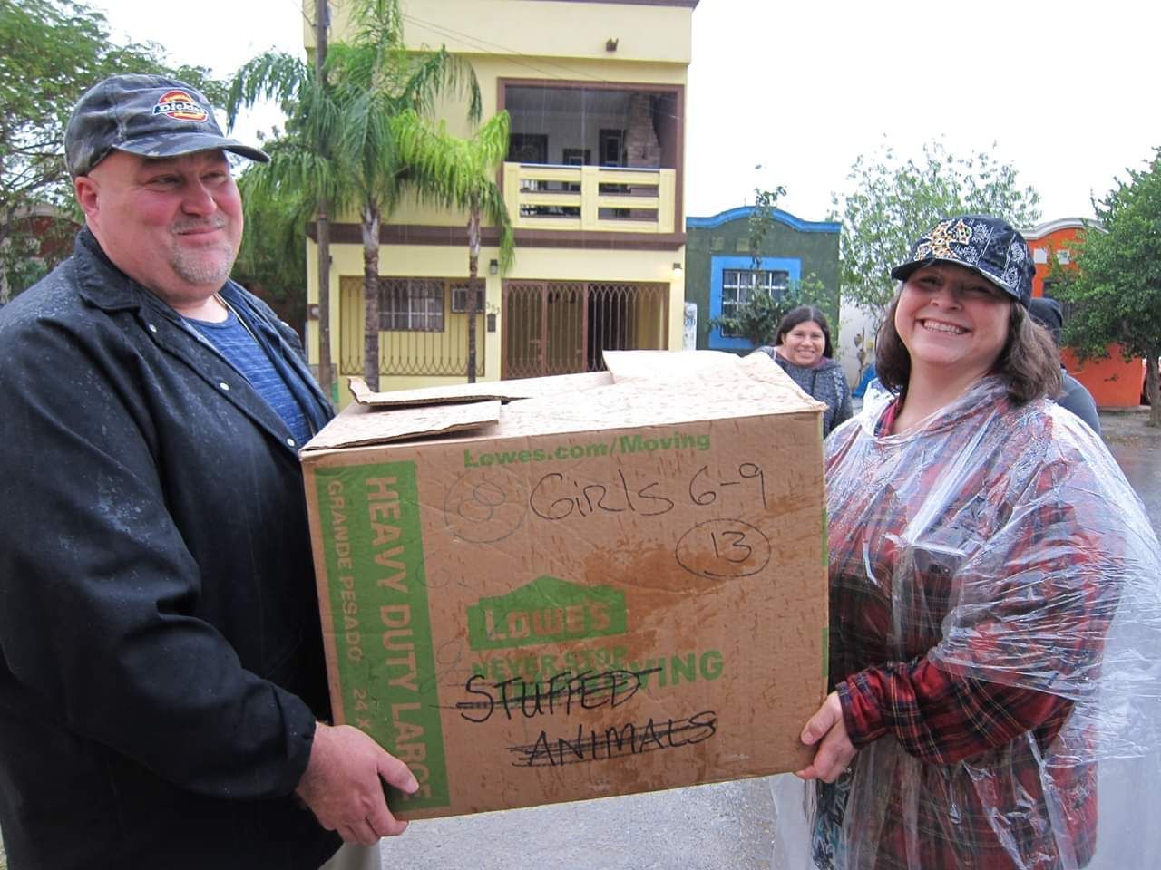 Lori and Jeremy Cooper Carrying a box of gifts for kids in Mexivo
