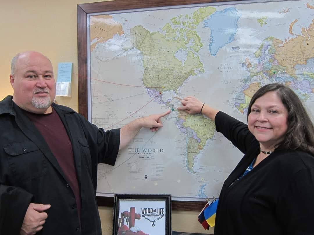 Jeremy and his wife pointing to a map of Mexico