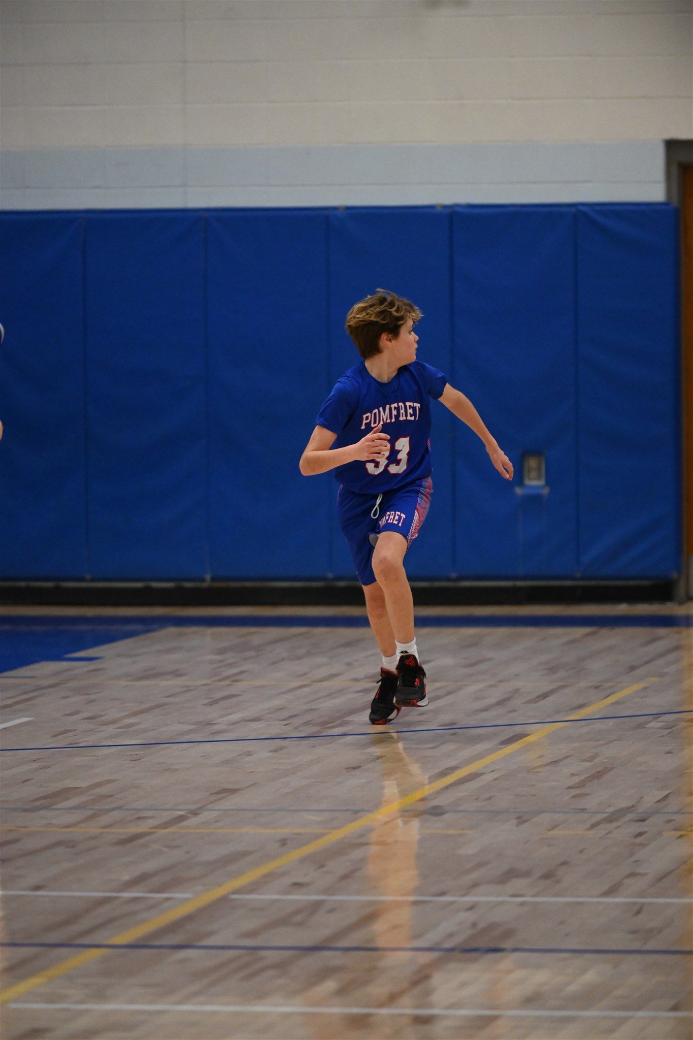 member of the 2023-24 boys basketball team on the court