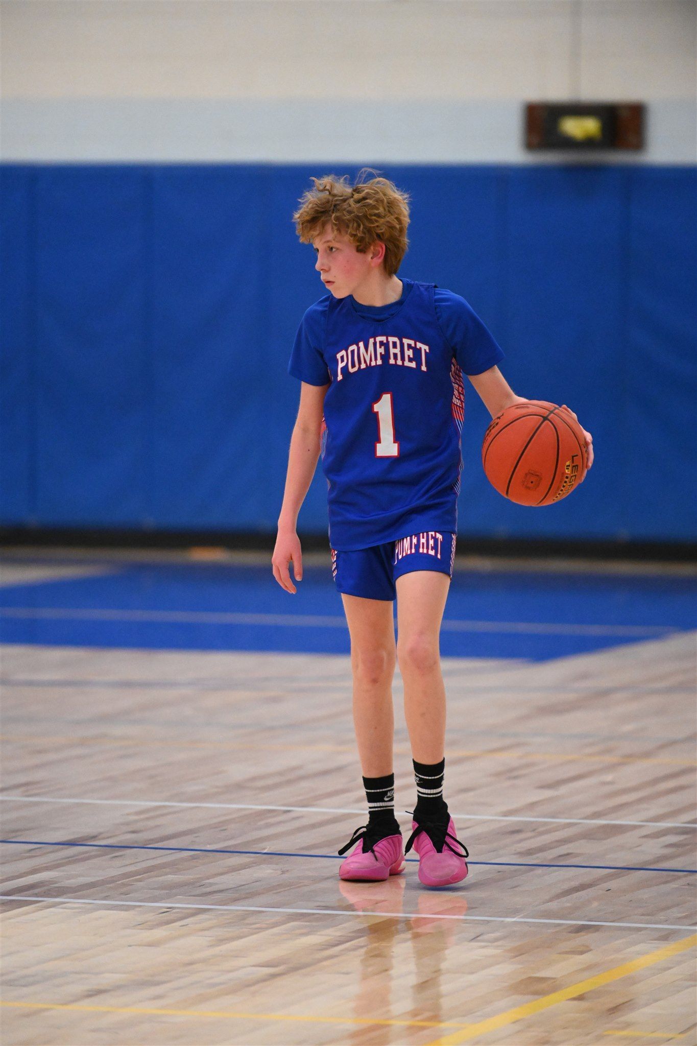 member of the 2023-24 boys basketball team on the court