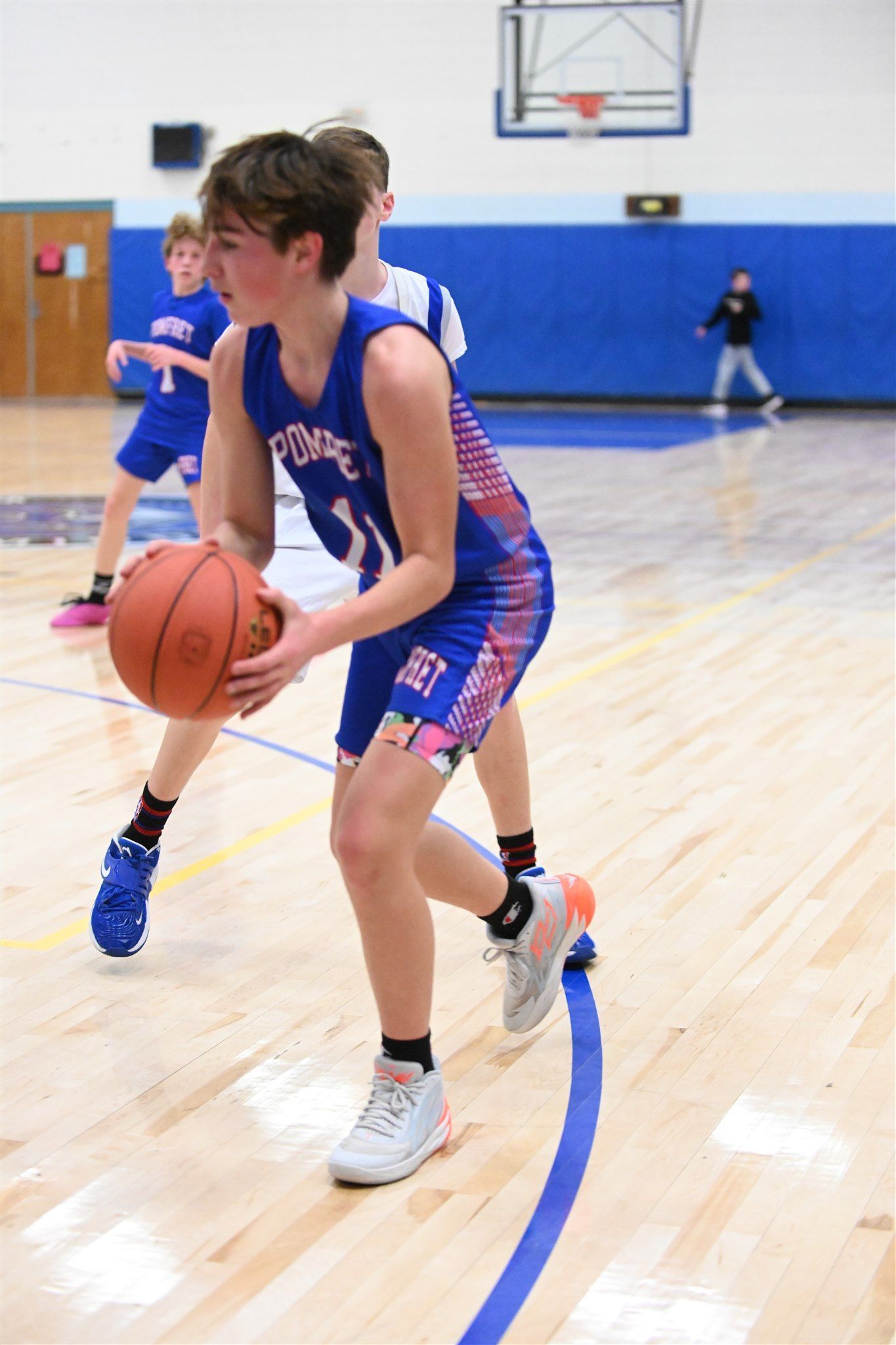 members of the 2023-24 boys basketball team on the court
