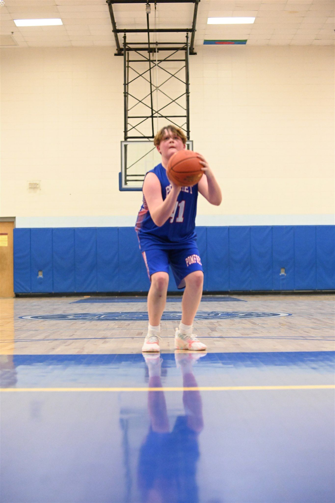 member of the 2023-24 boys basketball team on the court