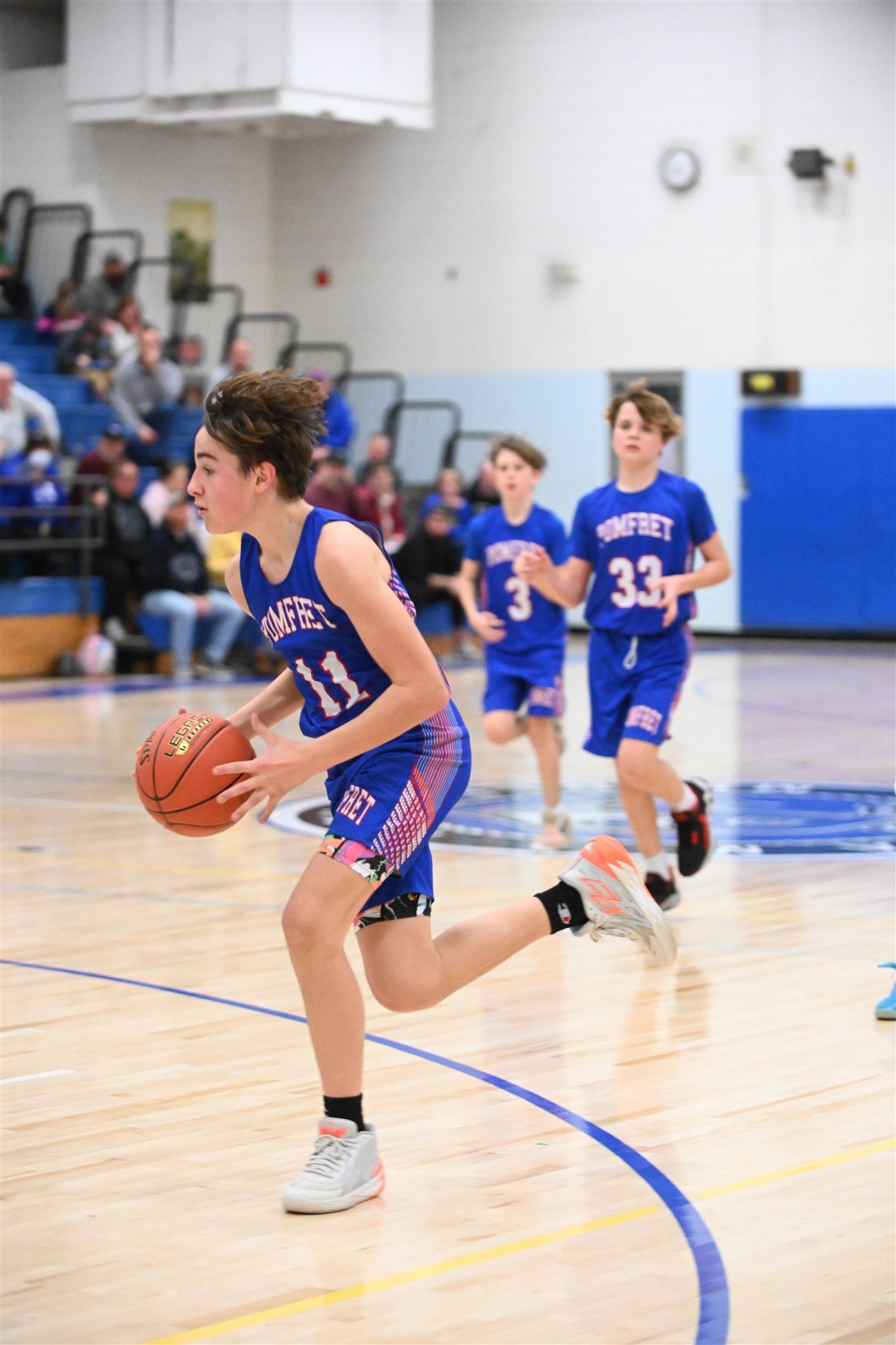members of the 2023-24 boys basketball team on the court