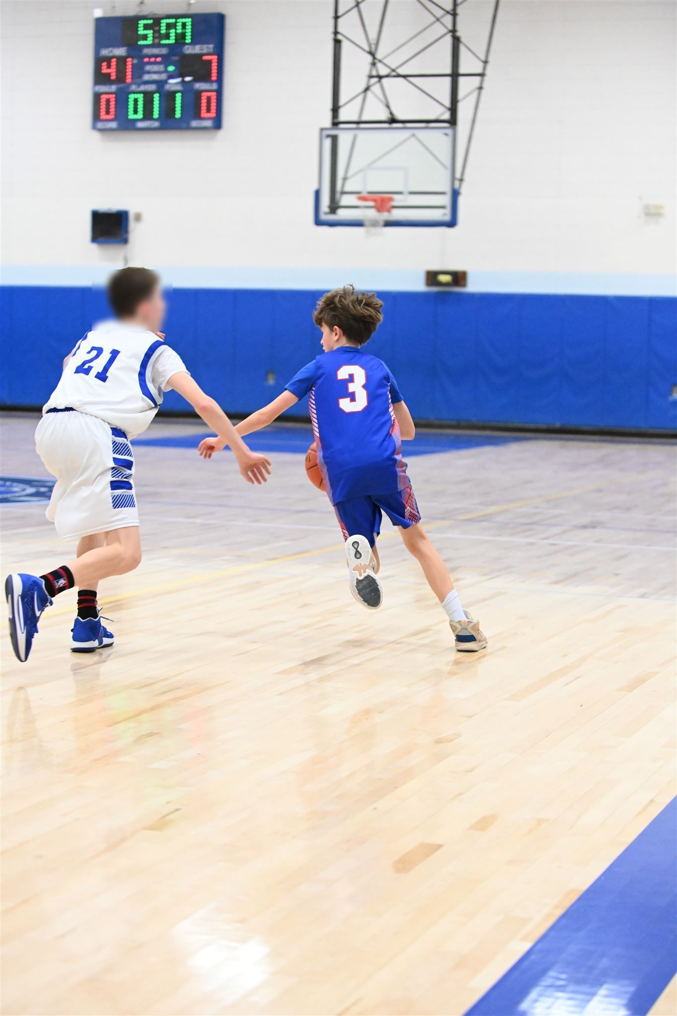 member of the 2023-24 boys basketball team on the court