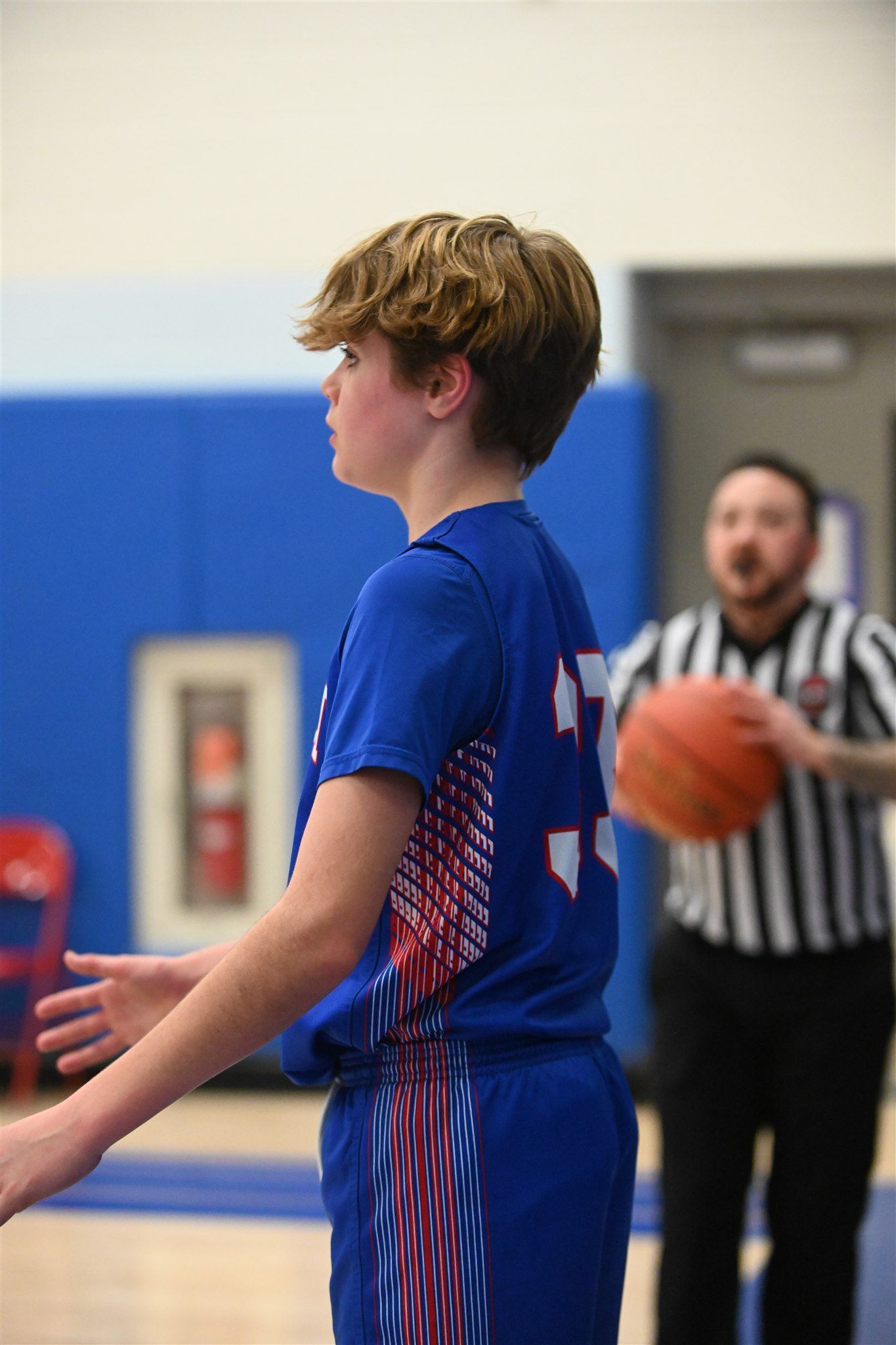 member of the 2023-24 boys basketball team on the court