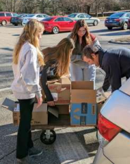 NJHS members unloading boxes for the Holidya Shop