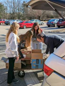NJHS students unloading product to help with the Holiday Shop