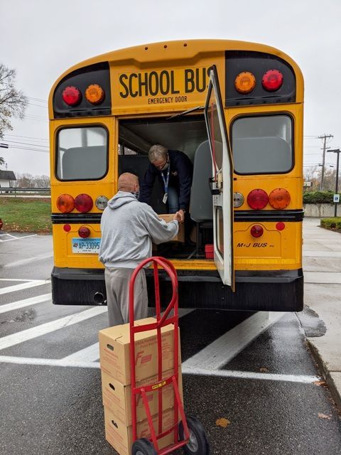 Loading a school bus with food for Farm to Families Program
