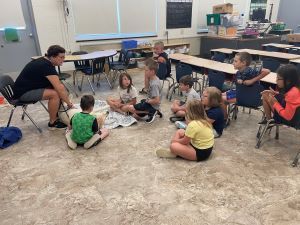 Photo of Kate Bars and her therapy dog Sadie visiting students