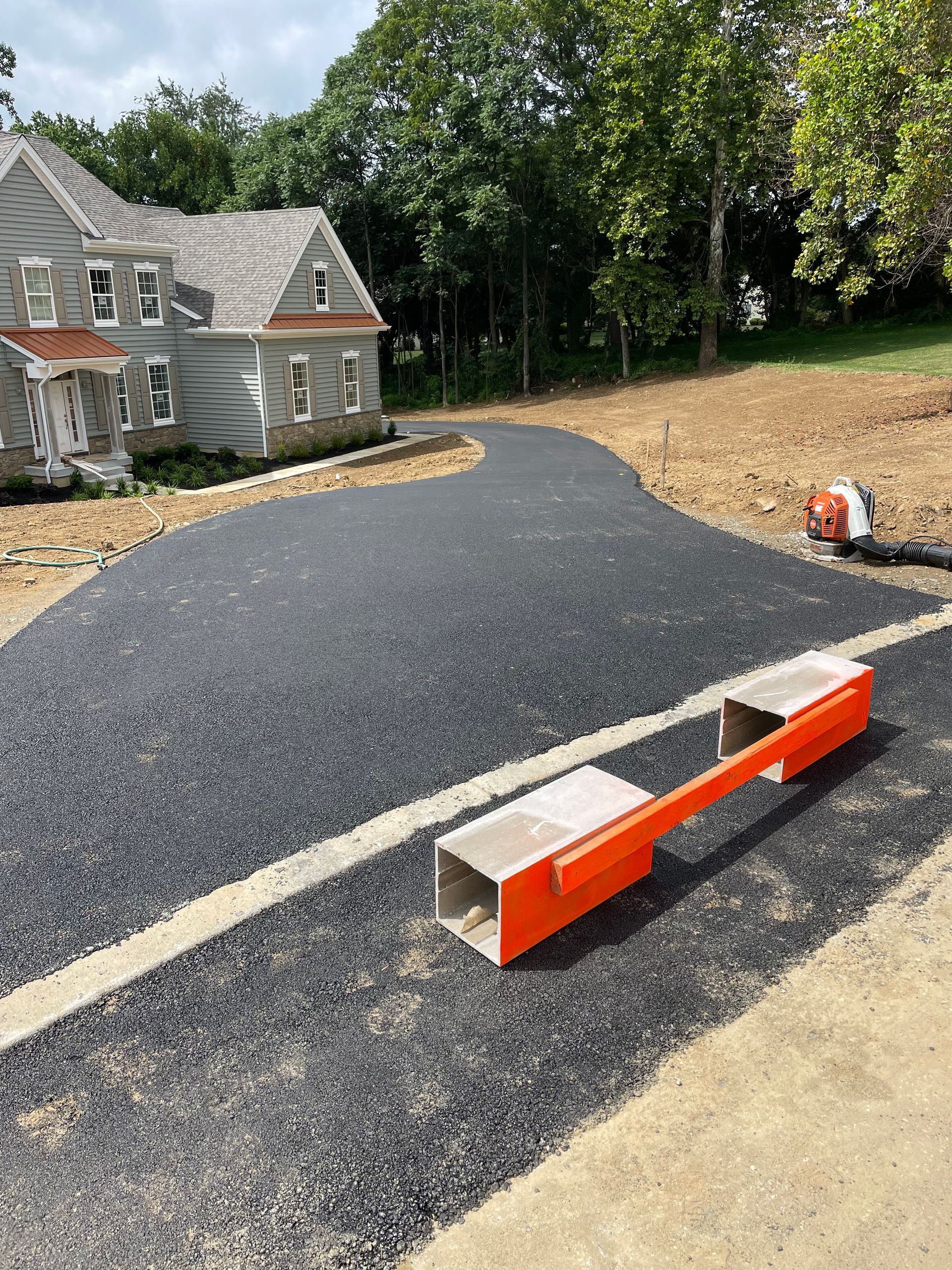 A driveway is being built in front of a house.