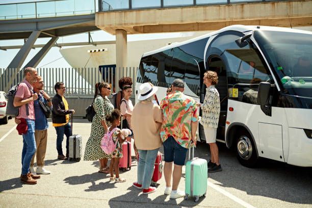 A group of people are standing in front of a bus.