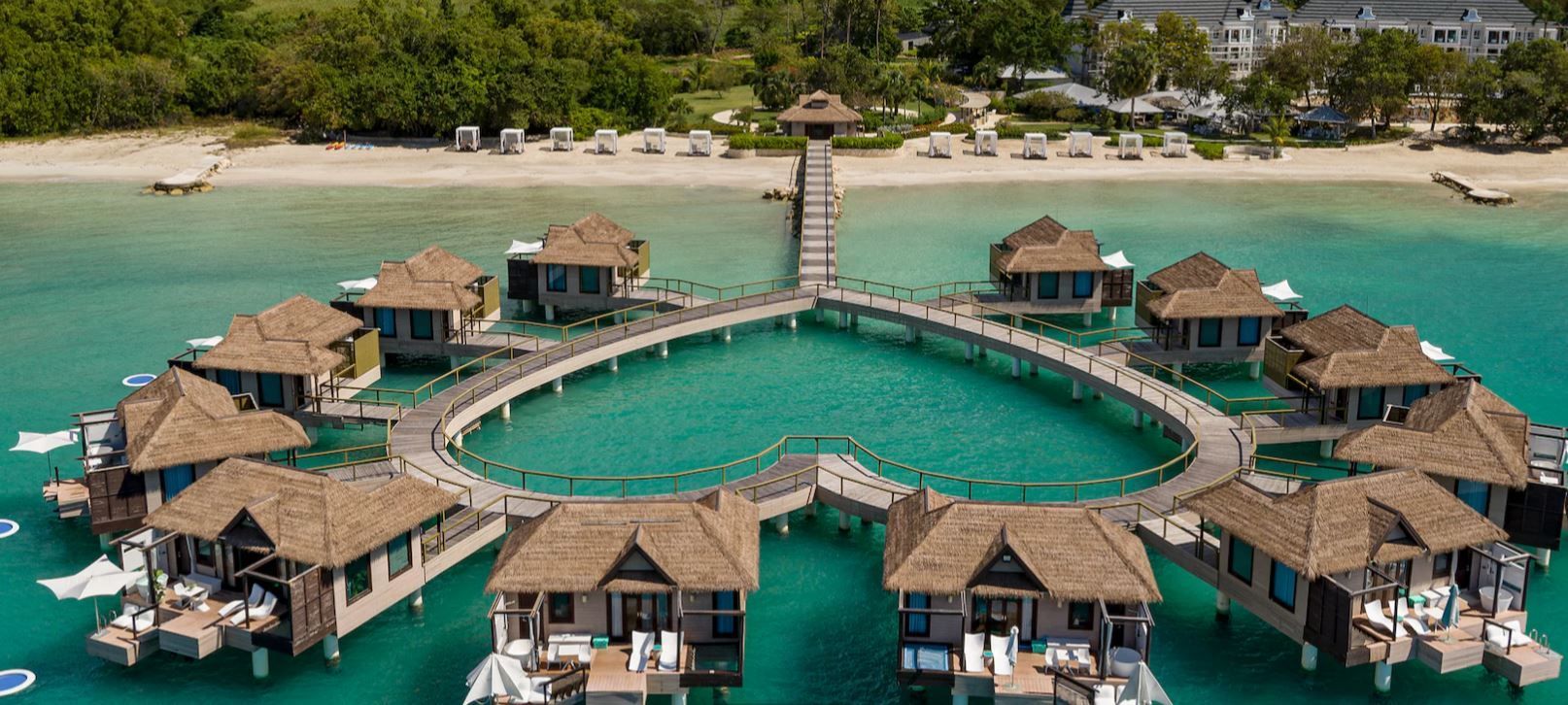 A group of houses on stilts in the middle of the ocean.