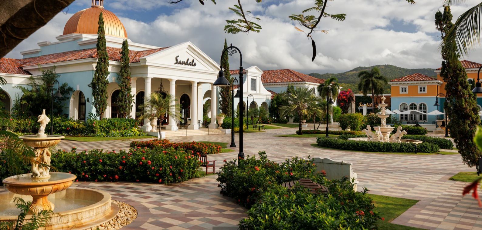 There is a fountain in front of a large building.