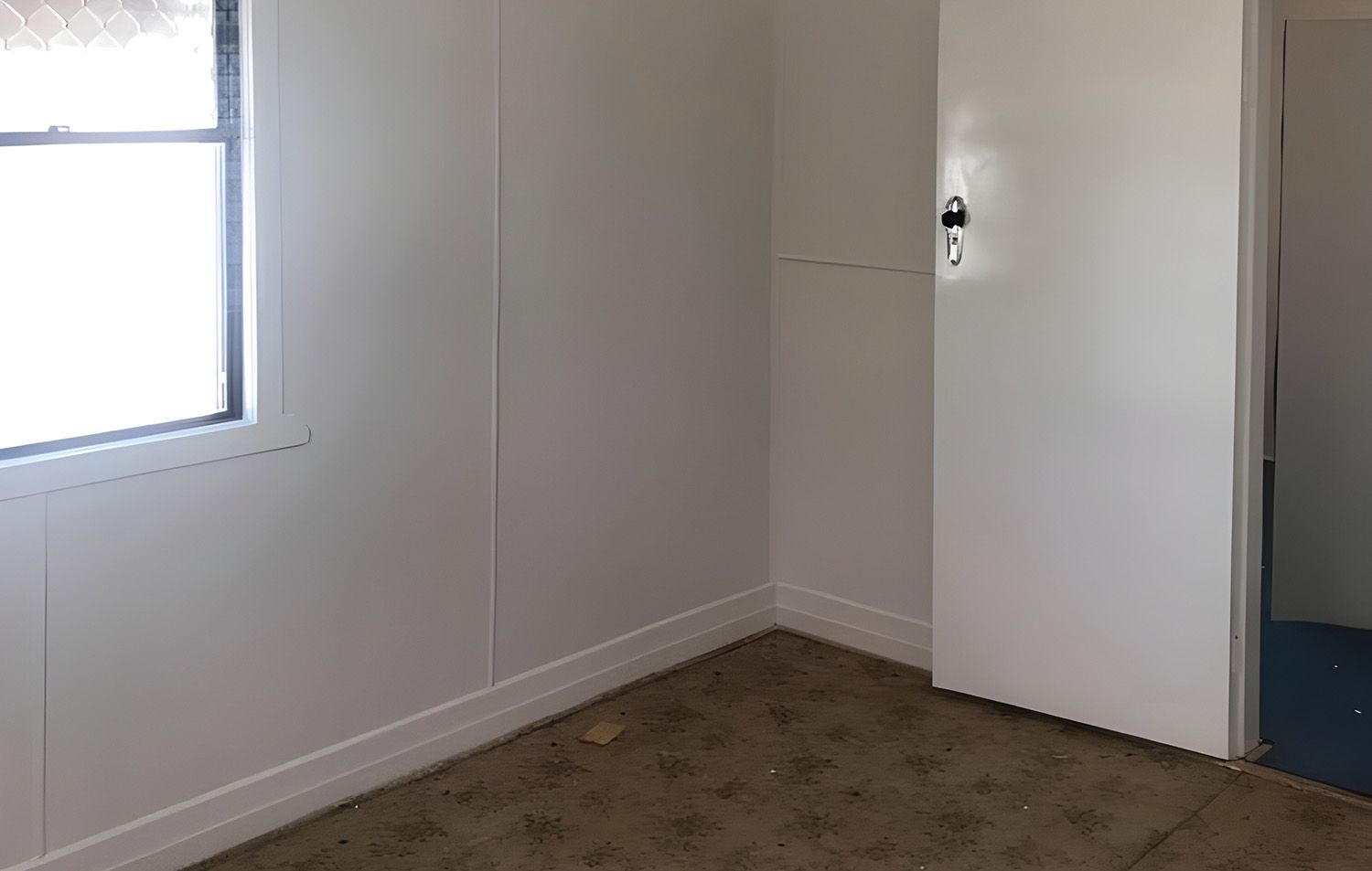 Freshly Painted Empty Room With A Window And A Door