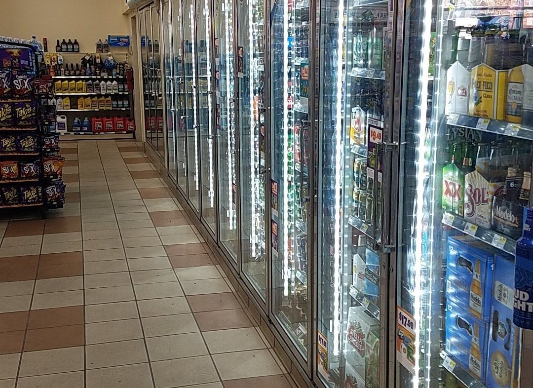 A man is fixing a light fixture in a living room.