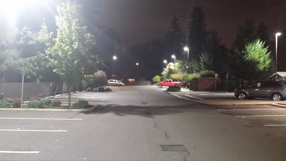 A parking lot with cars parked in it at night.