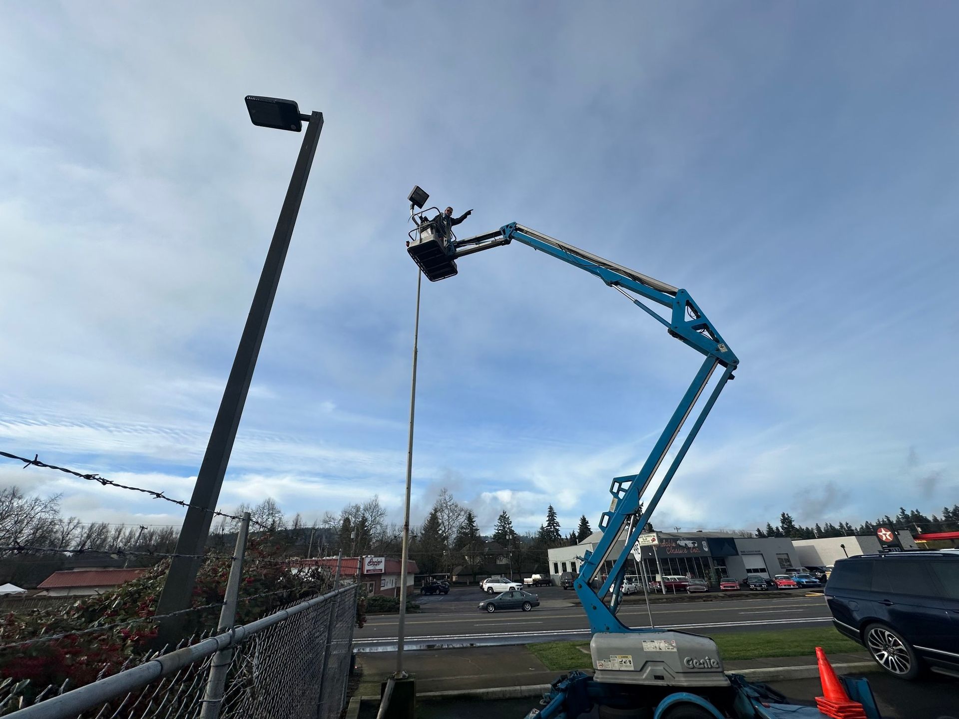A man is standing on a lift with the number 34/19 on it