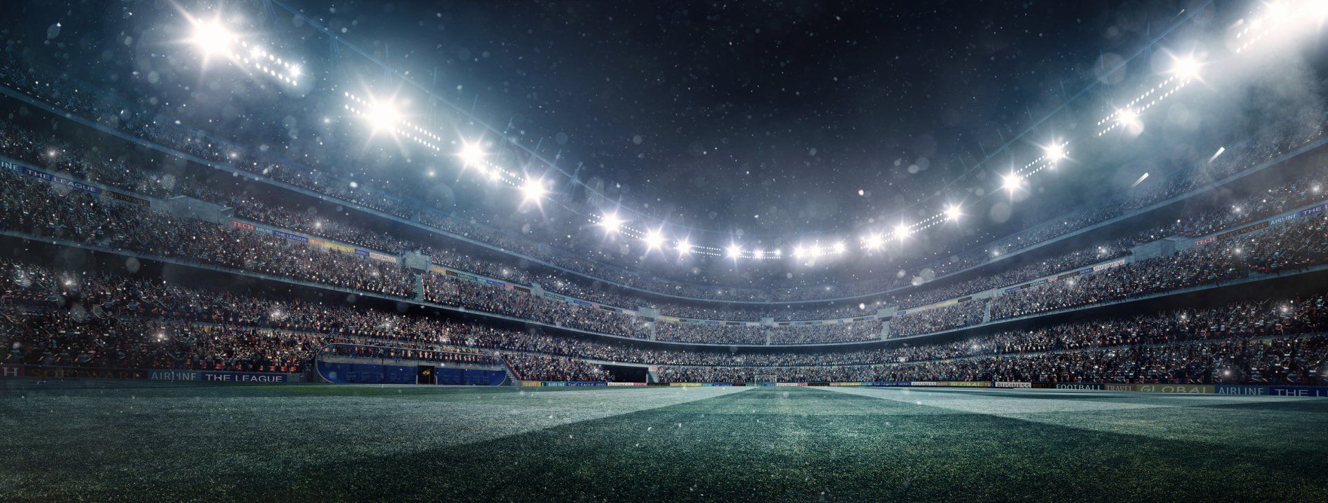 An empty soccer stadium with a crowd of people watching a game at night.