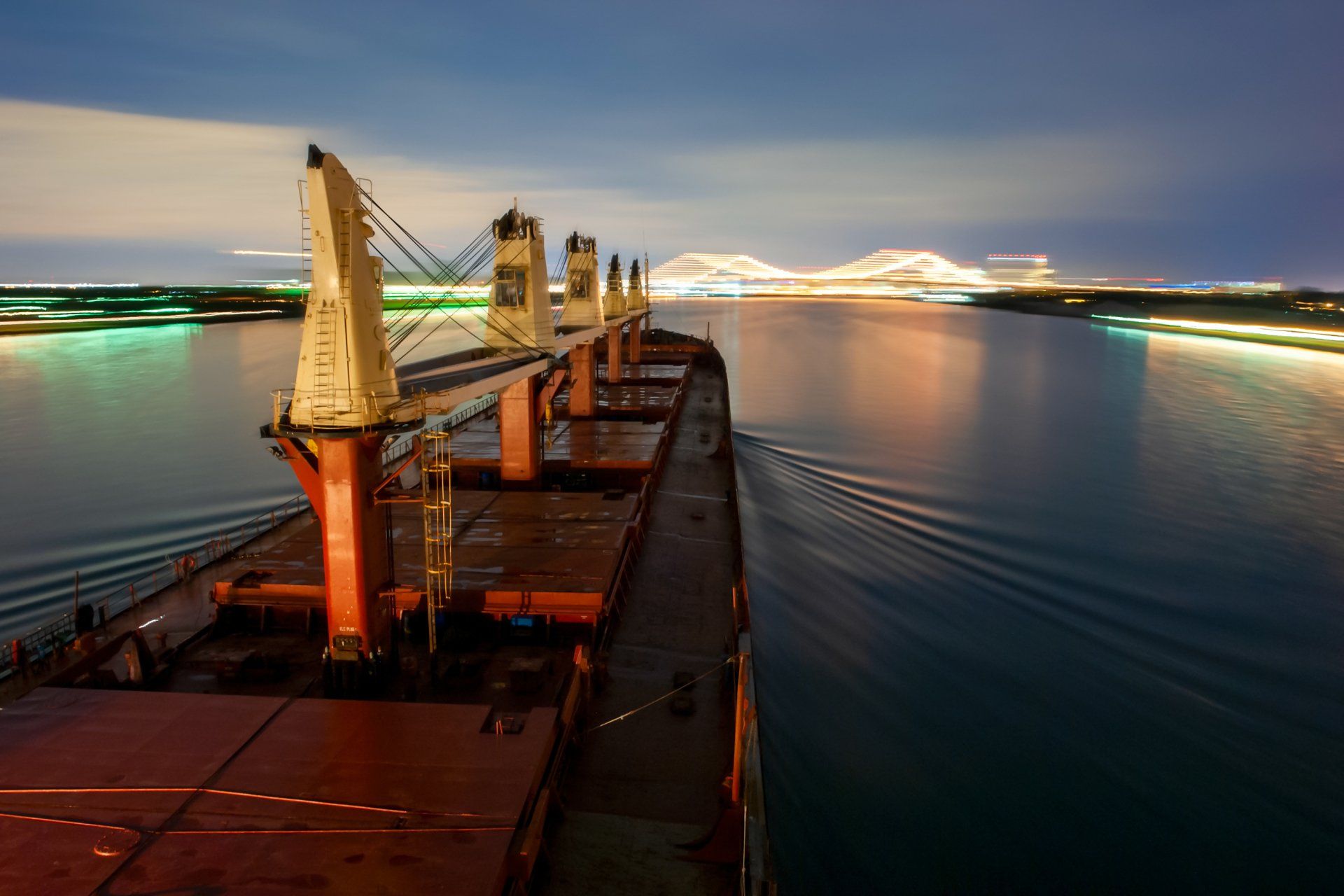 A large ship is floating on top of a body of water at night.