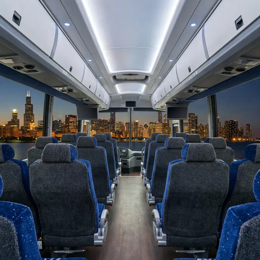 Interior of a bus, rows of blue and black seats, overlooking a nighttime cityscape with bright lights.