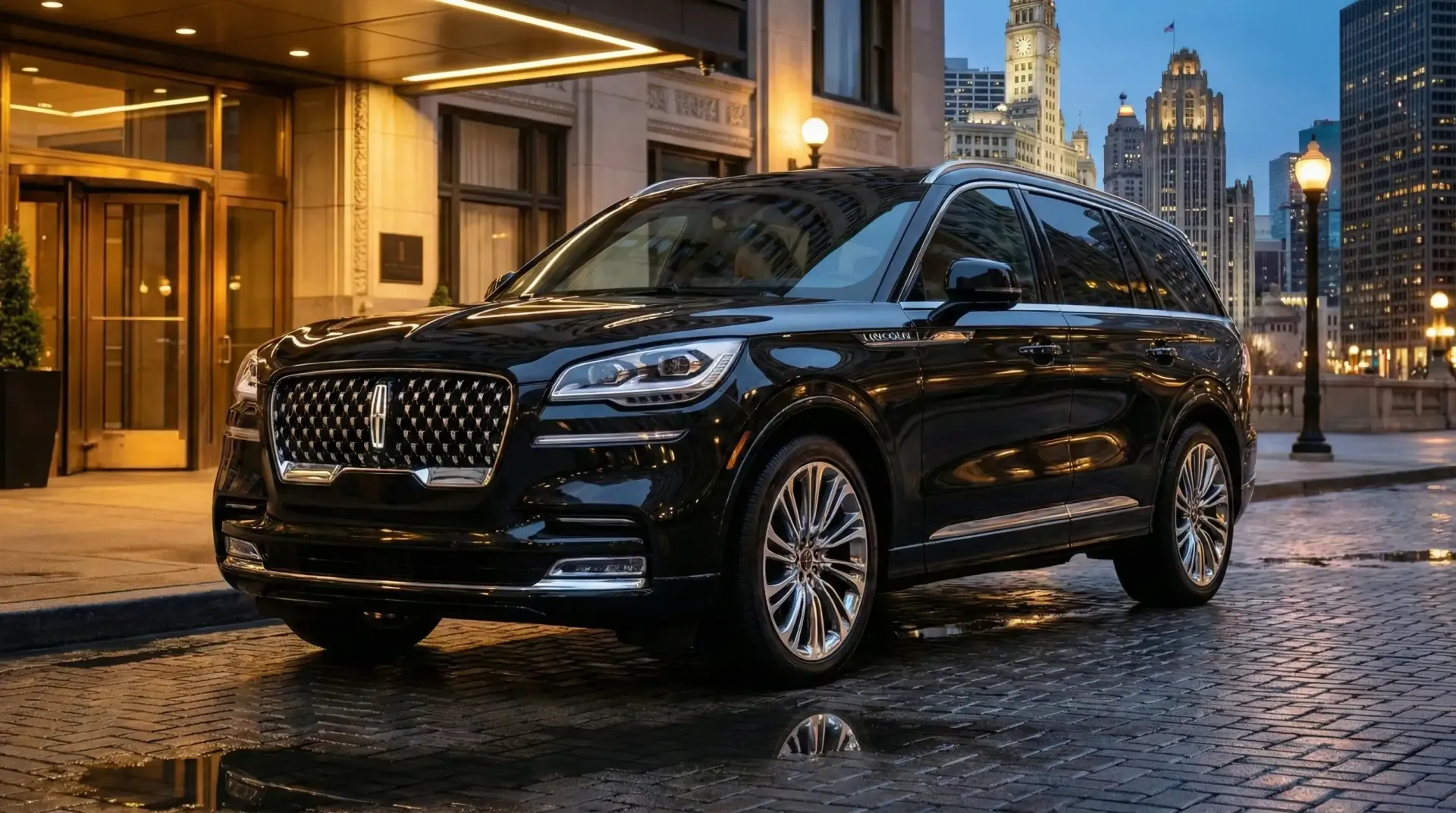 Black Lincoln Aviator SUV parked on a cobblestone street in front of a building at night.
