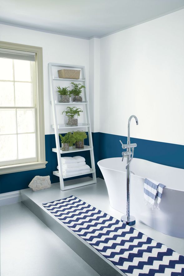 Paint sample display wall at Benjamin Moore, with rows of color swatches in a paint store