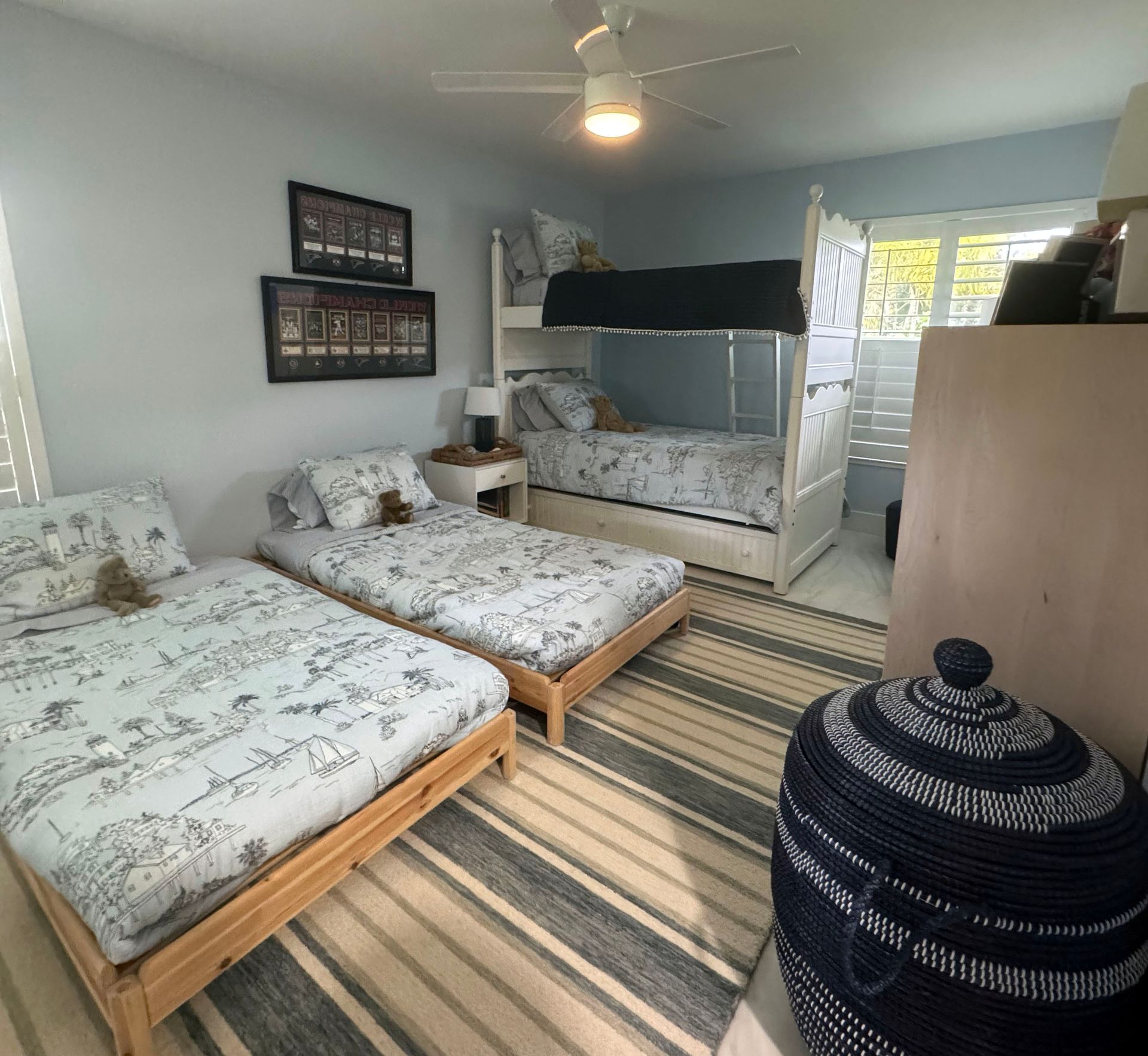 A bedroom with two beds and a bunk bed