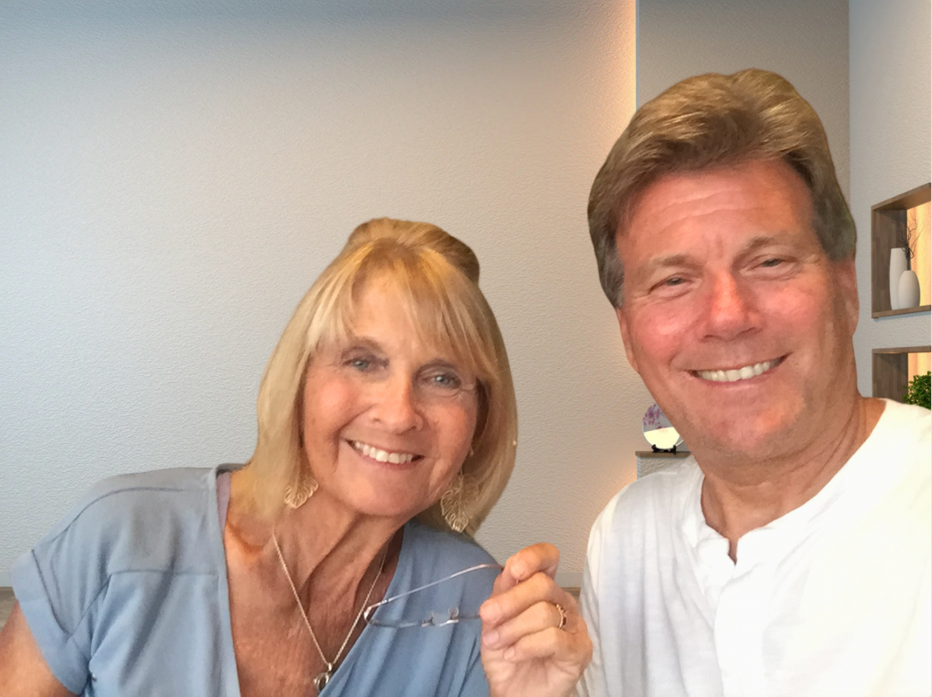 A man and a woman are posing for a picture and smiling