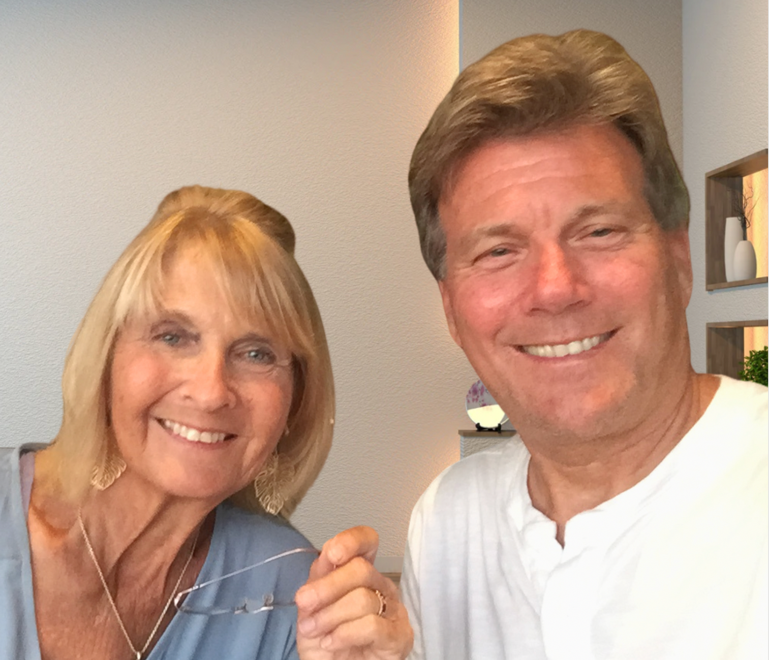 A man and a woman are posing for a picture and smiling