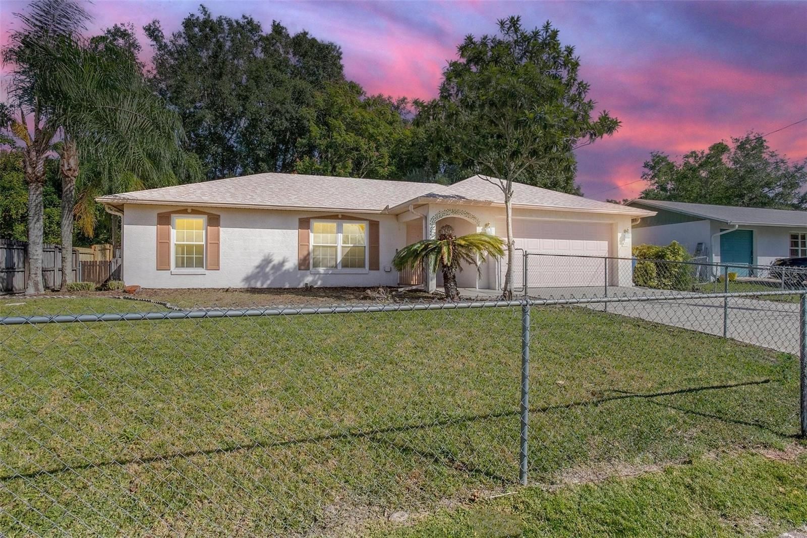 Beautiful home in Central Florida with sunset in background.