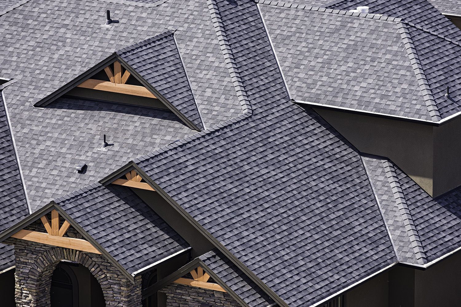Rooftop in a newly constructed subdivision showing asphalt shingles. Rooftop in a newly constructed subdivision showing asphalt shingles.