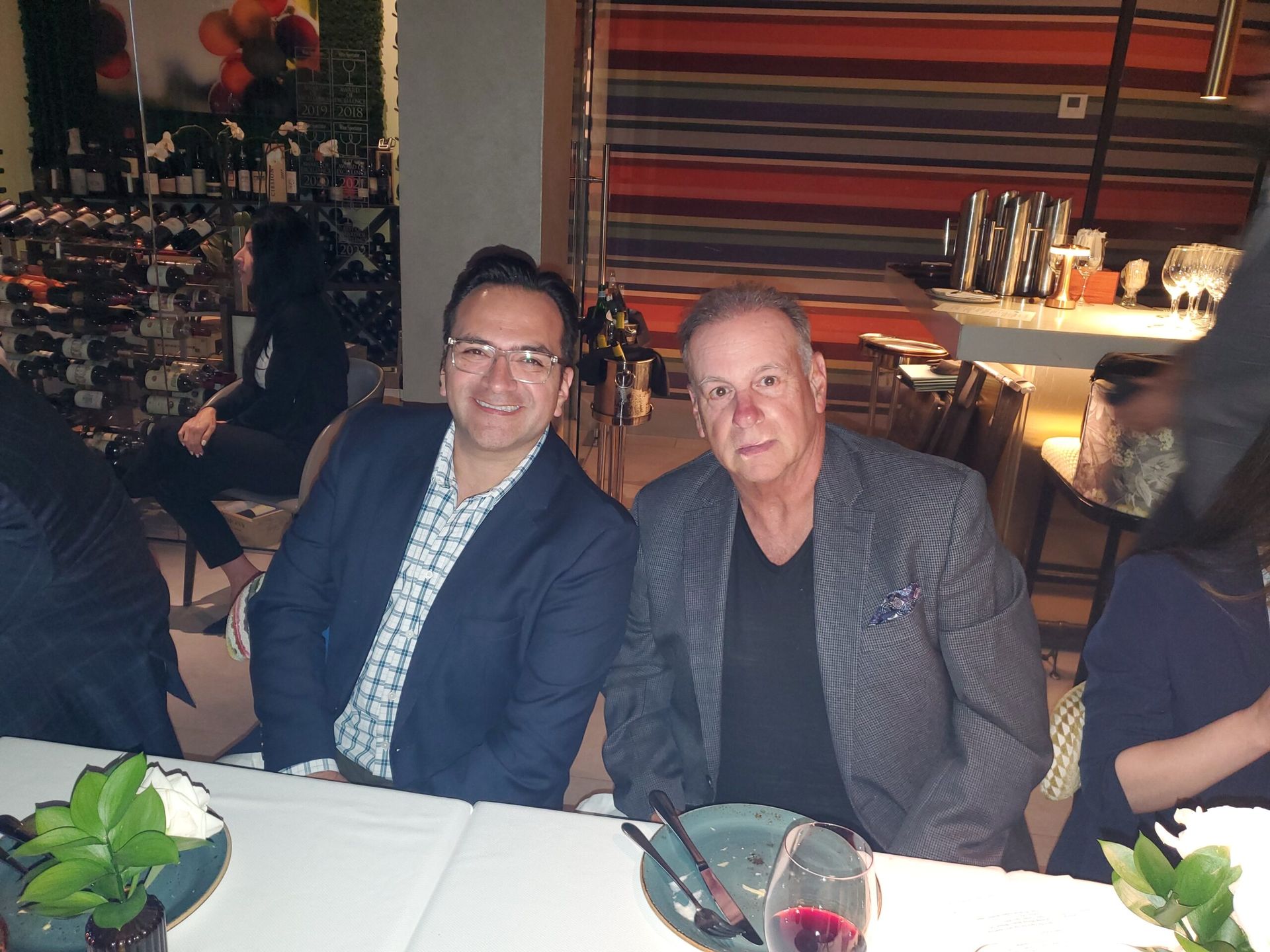 Two men are sitting at a table in a restaurant
