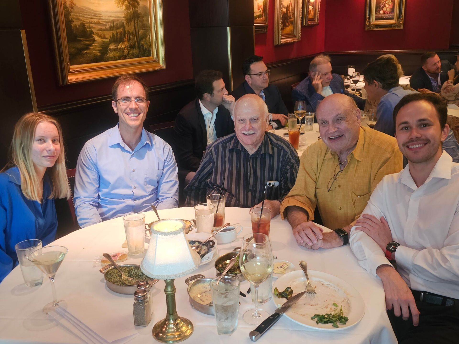 A group of people are sitting at a table in a restaurant