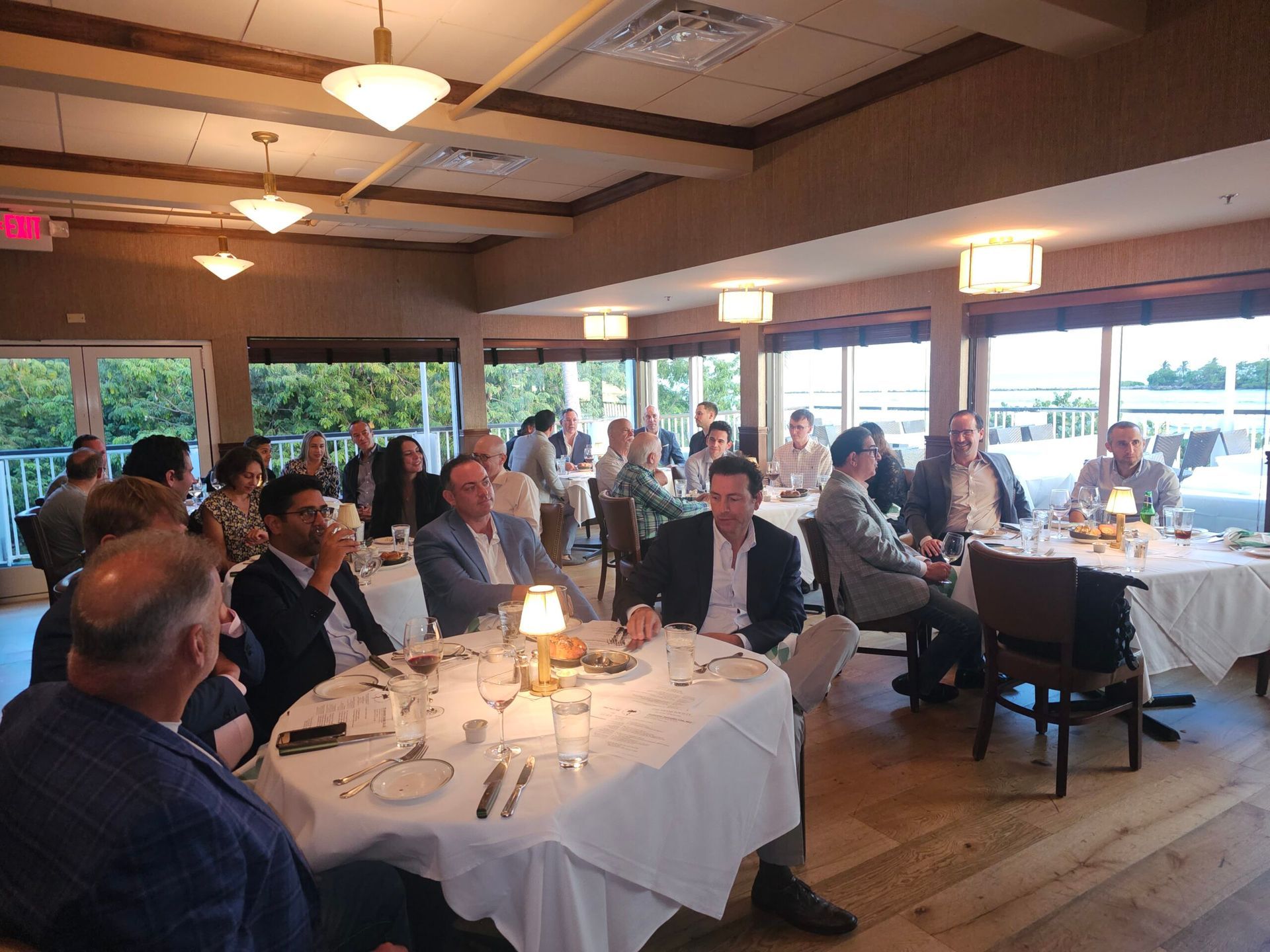 A group of people are sitting at tables in a restaurant.
