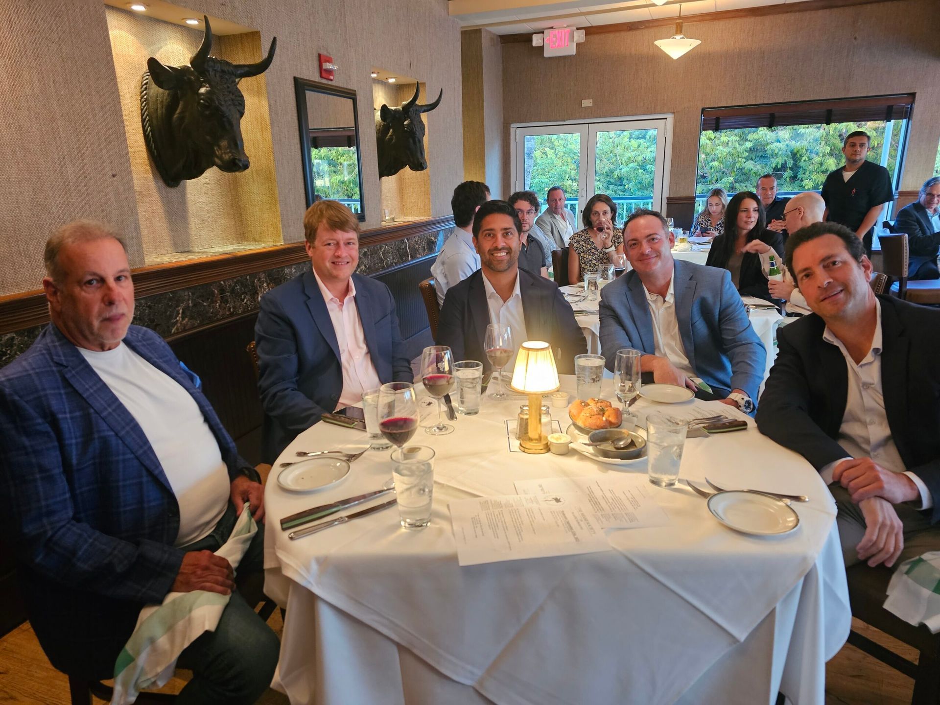 A group of men are sitting at a table in a restaurant.