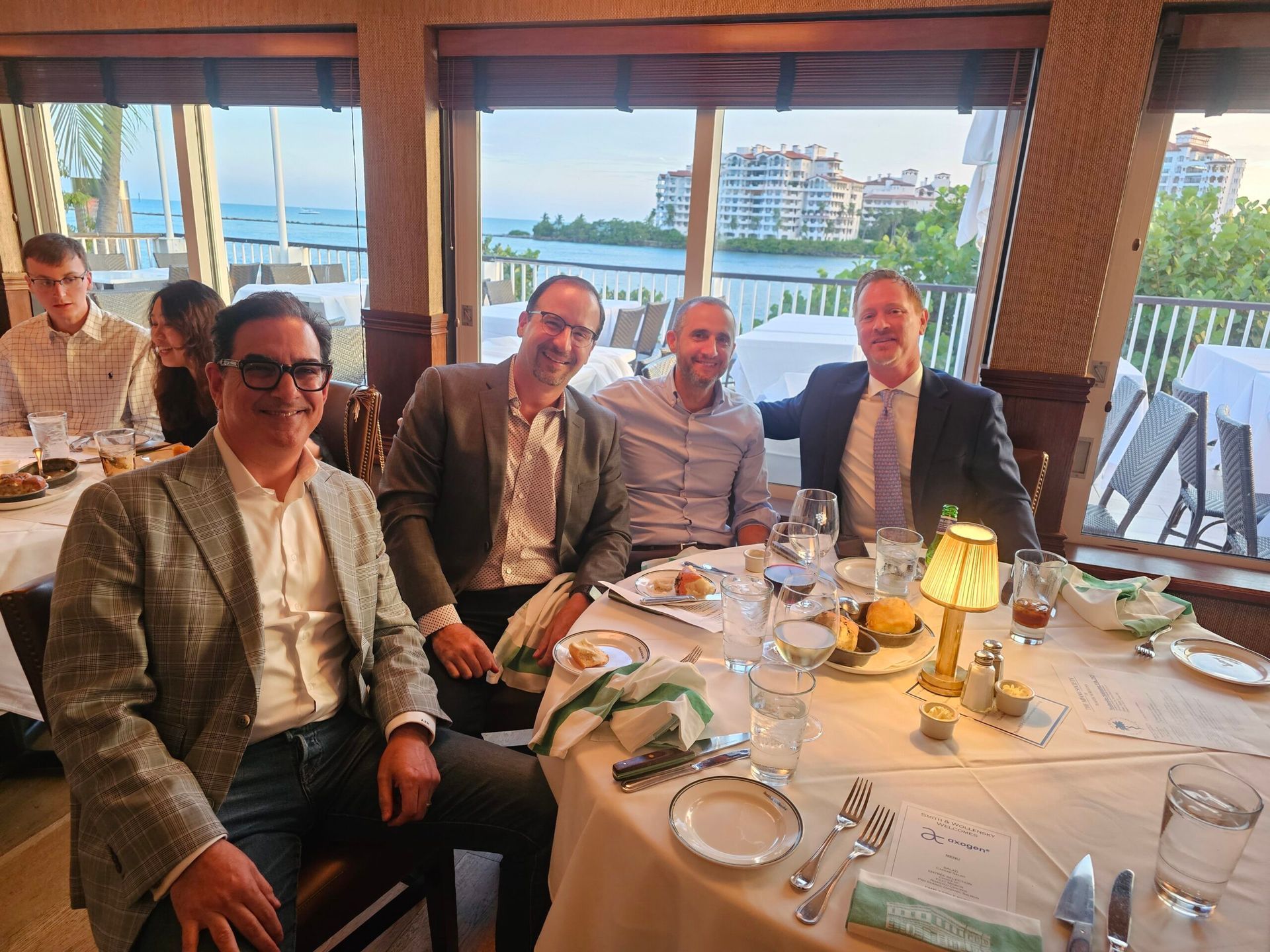 A group of men are sitting at a table in a restaurant.