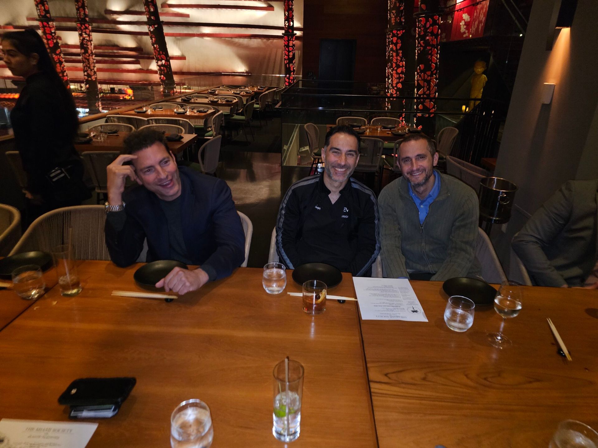 A group of men are sitting at a table in a restaurant