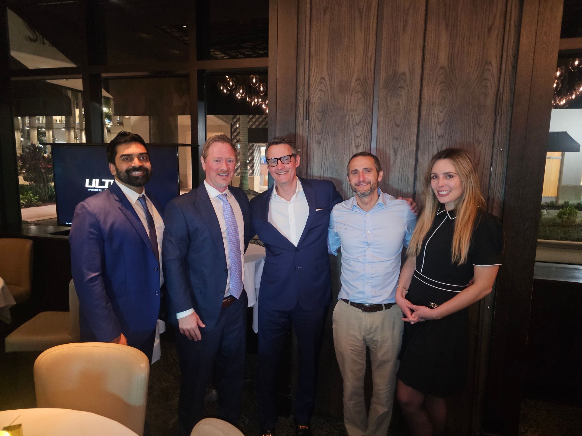 A group of people posing for a picture in a restaurant