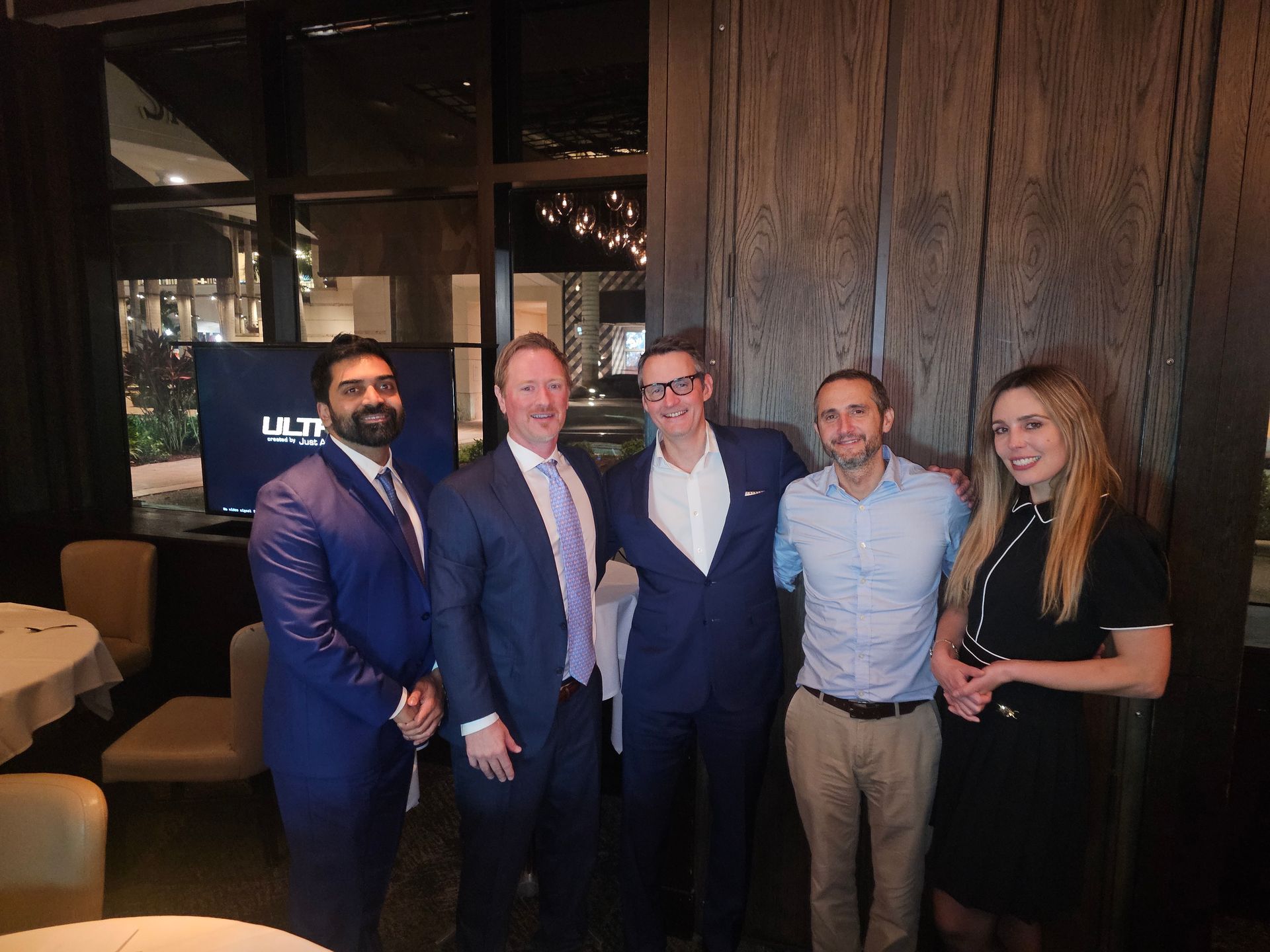 A group of people are posing for a picture in a room.