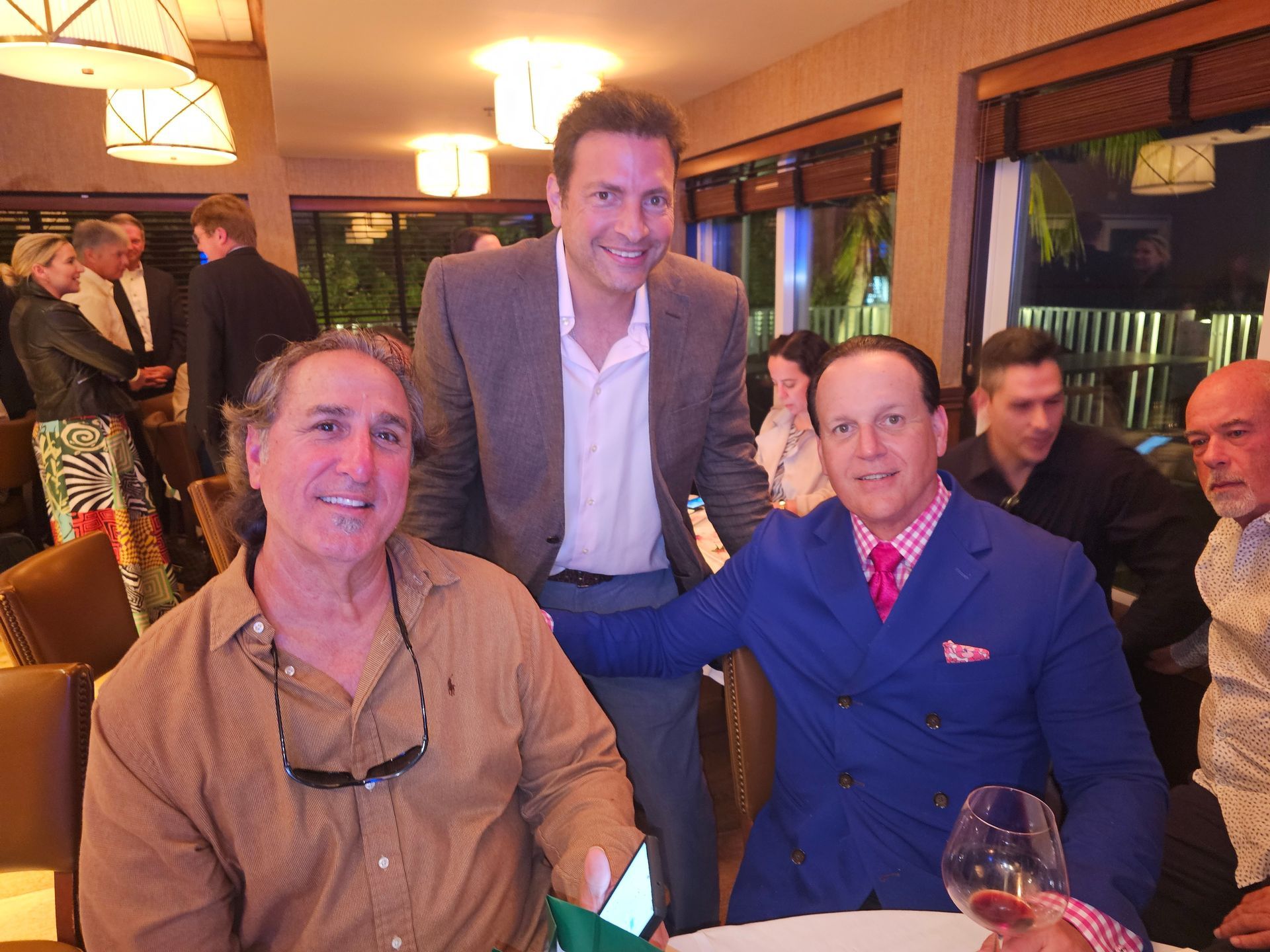 A group of men are posing for a picture in a restaurant