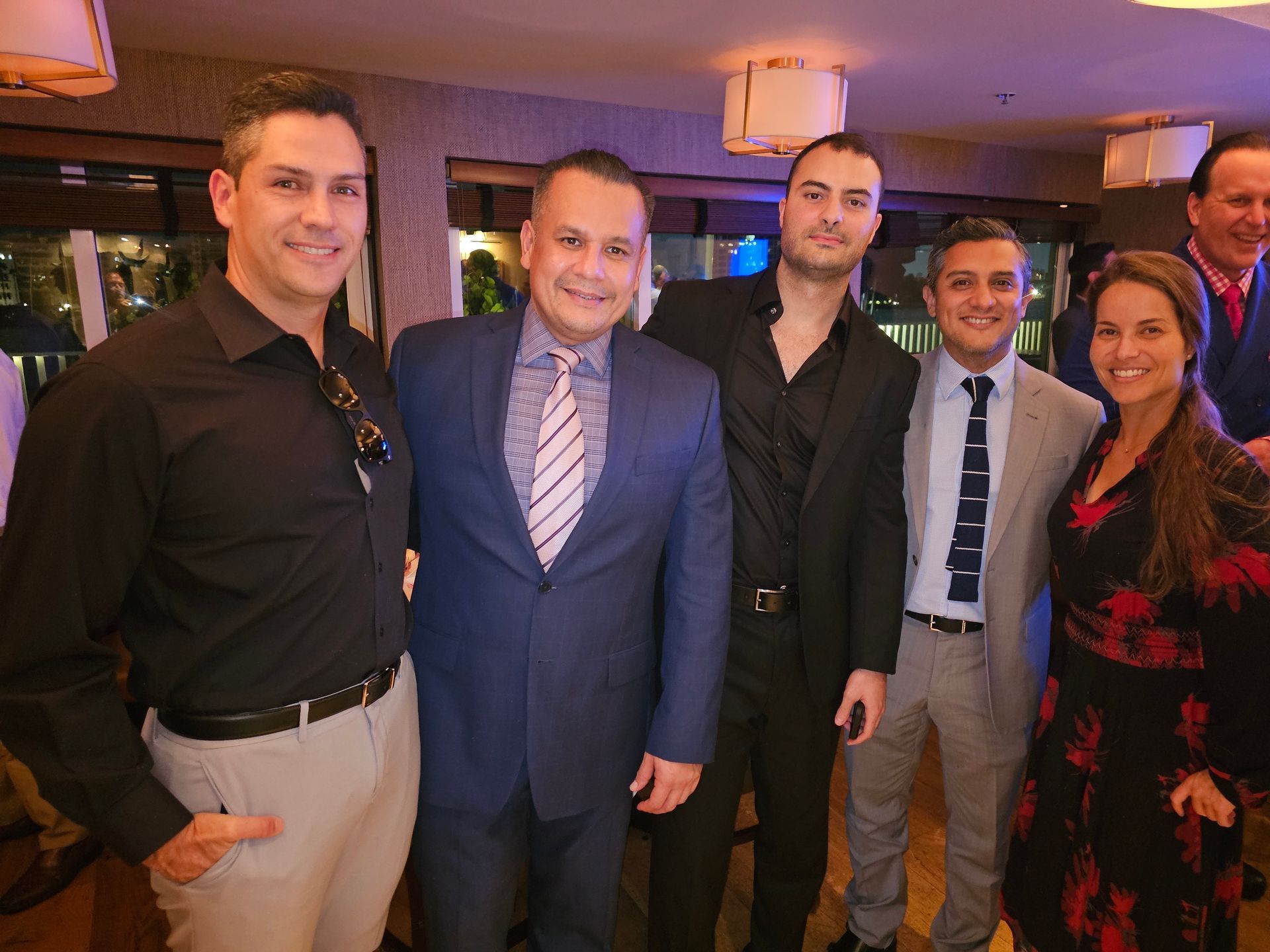 A group of men in suits and ties are posing for a picture.