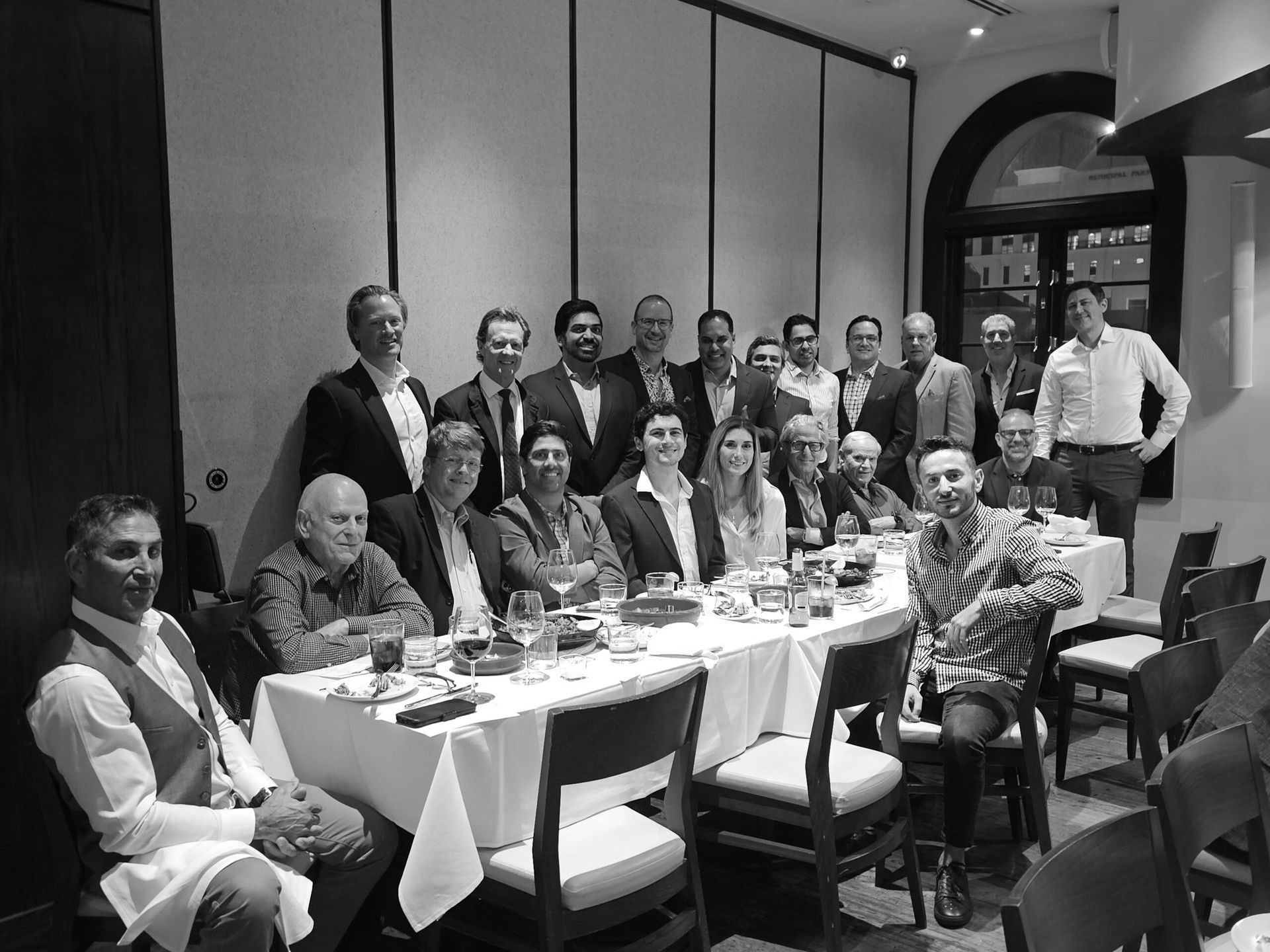 A group of Miami Society of Plastic Surgeons members are building relationships at a dinner meeting.