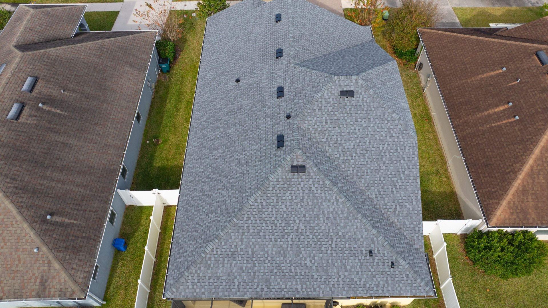 Top-down drone photo of a completed CertainTeed Landmark Pewter architectural shingle roof replacement in Avalon Park, Wesley Chapel, FL.