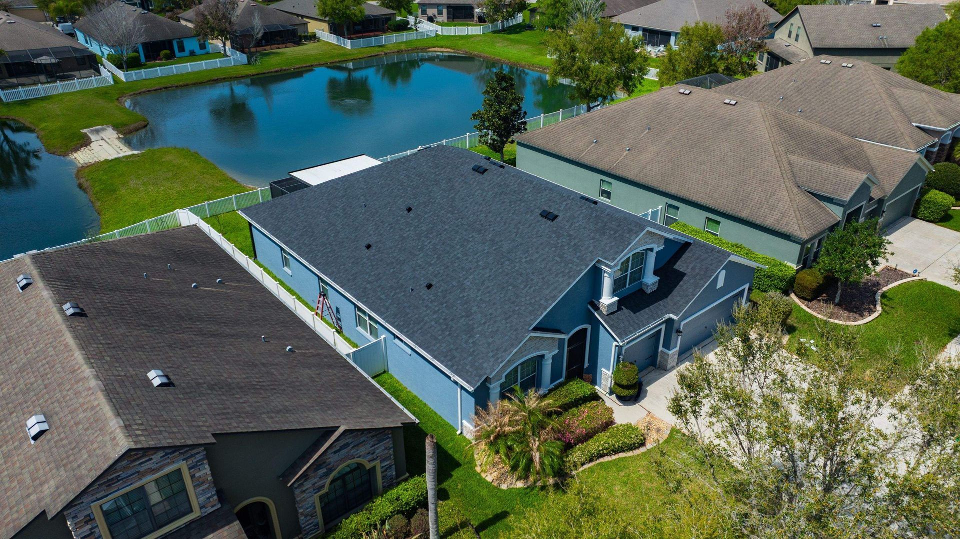 Front aerial view of a newly installed CertainTeed Landmark Charcoal Black shingle roof on a residential home in Wesley Chapel, FL.