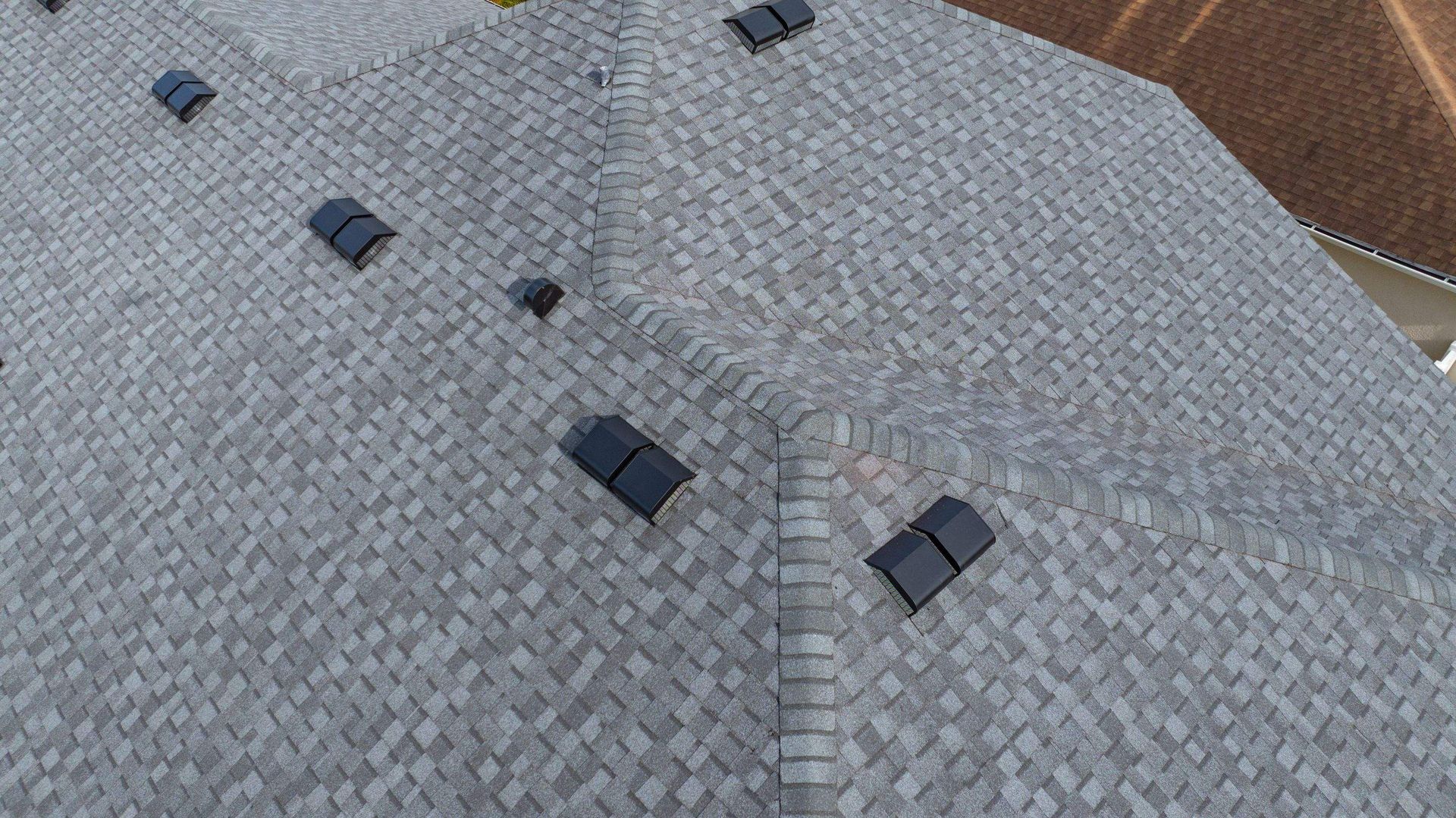 Close-up aerial view of a newly installed CertainTeed Landmark Pewter architectural shingle roof in Avalon Park, Wesley Chapel, Florida.