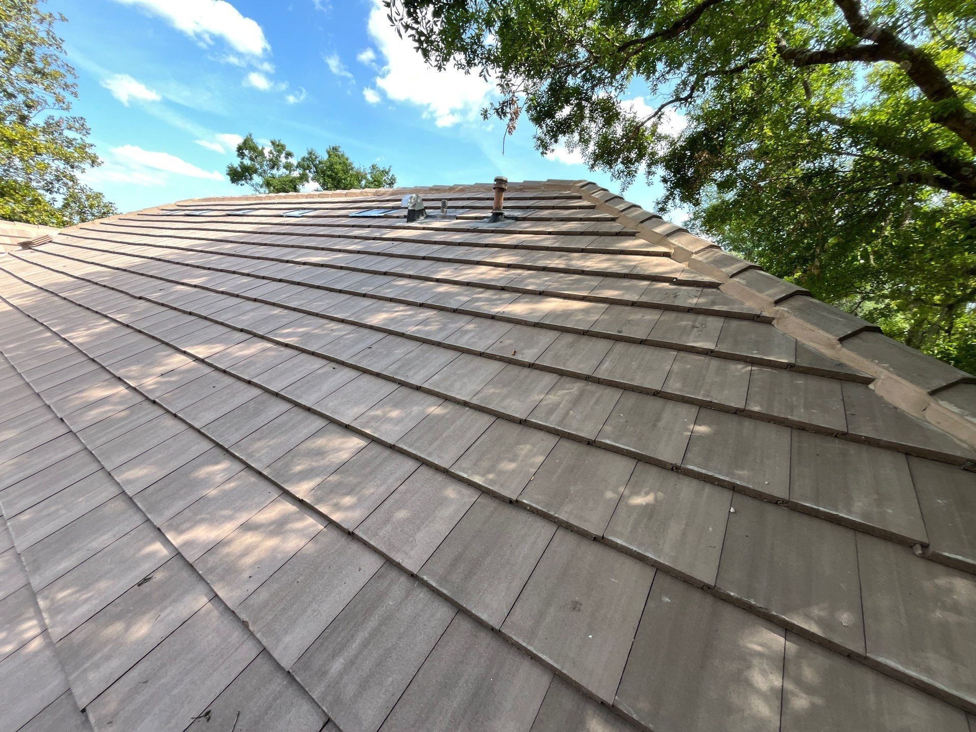Aerial view of a newly installed CertainTeed Landmark Charcoal Black shingle roof on a residential home in Wesley Chapel, FL.