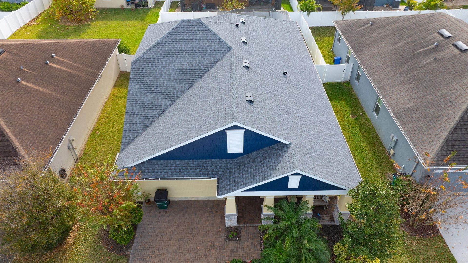 Front aerial view of a completed CertainTeed Landmark Pewter shingle roof replacement at a home in Avalon Park, Wesley Chapel, Florida.