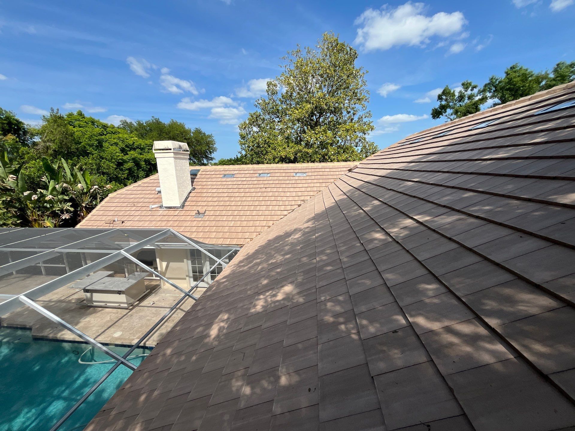 Aerial view of a CertainTeed Landmark Charcoal Black asphalt shingle roof replacement in Oak Creek HOA Wesley Chapel, FL.